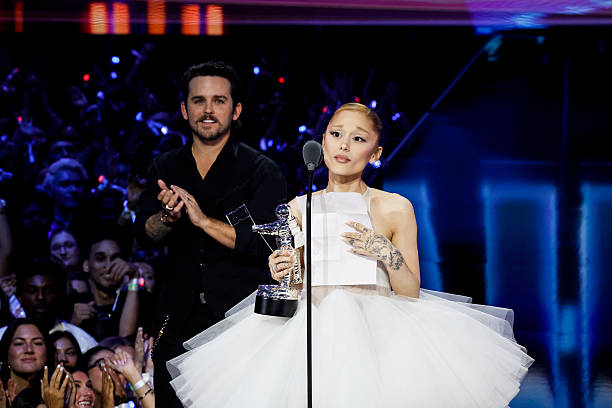Ariana Grande accepts the Video of the Year award while director Christian Breslauer looks on at the 2025 MTV Video Music Awards at New York's UBS Arena in Elmont, N.Y. The show airs LIVE on the CBS Television Network and simulcast on MTV on Sunday, Sept. 7 , and streams on Paramount+. Photo credit: Mary Kouw/CBS ©2025 CBS Broadcasting, Inc. All Rights Reserved. — frame 24/78 (612×408)