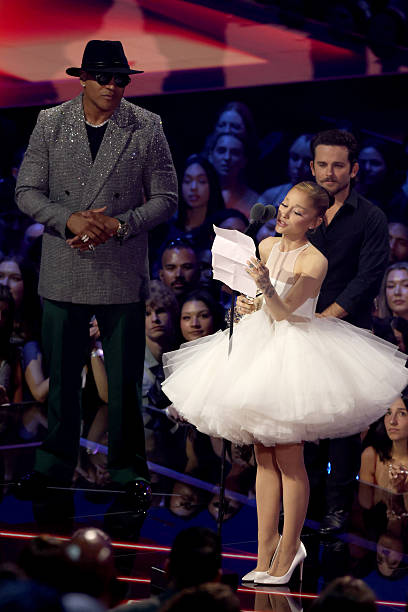 Ariana Grande and Christian Breslauer accept the Video of the Year Award for “Brighter Days Ahead” from LL Cool J onstage during the 2025 MTV Video Music Awards at UBS Arena on September 07, 2025 in Elmont, New York. (408×612)
