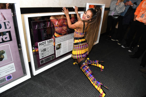 Ariana Grande poses backstage with commemorative plaques from Billboard during the Sweetener World Tour - Opening Night 