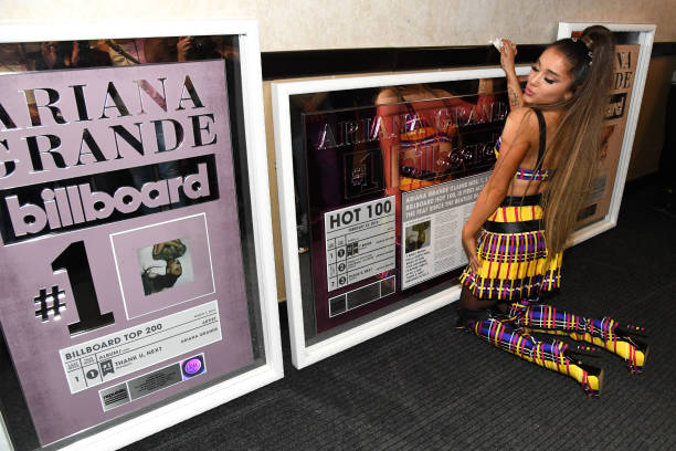 Ariana Grande poses backstage with commemorative plaques from Billboard during the Sweetener World Tour - Opening Night 