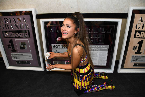 Ariana Grande poses backstage with commemorative plaques from Billboard during the Sweetener World Tour - Opening Night 