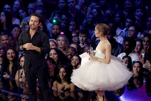 Christian Breslauer and Ariana Grande accept the Video of the Year Award for “Brighter Days Ahead” onstage during the 2025 MTV Video Music Awards at UBS Arena on September 07, 2025 in Elmont, New York. (612×408)