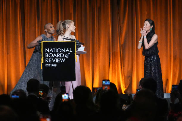 Cynthia Erivo, Ariana Grande, Michelle Yeoh speak onstage at The National Board of Review Gala held at Cipriani on January 7, 2025 in New York, New York. — frame 60/76 (612×409)