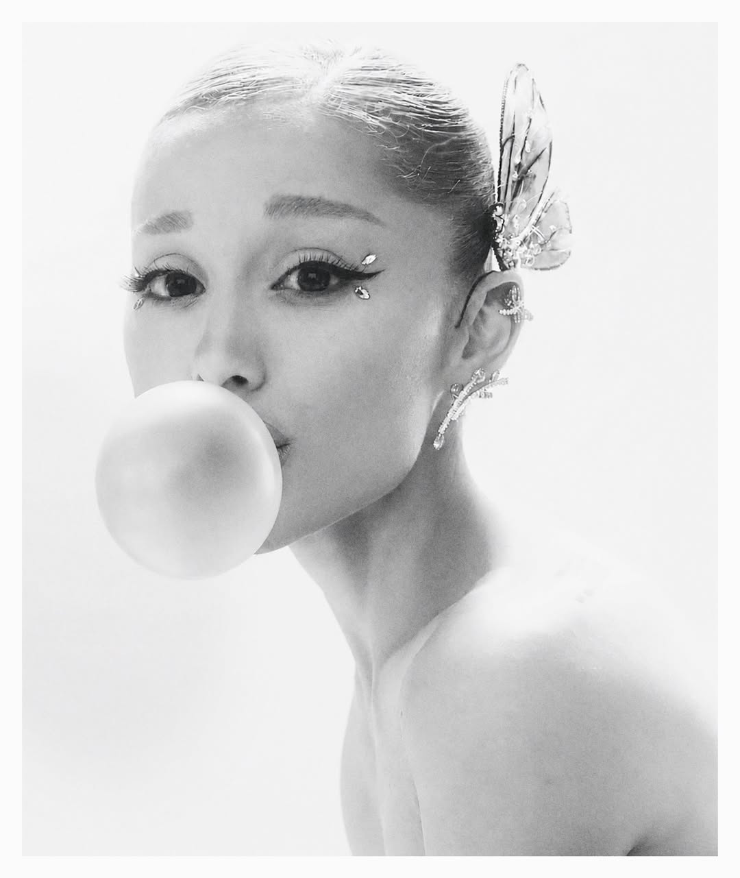 Photo shared by Ariana Grande on June 27, 2026 tagging @luxurylaw, @mertalas, @yvonneshelly, @manthony783, @alyxliu, @swarovski, and @r.e.m.beauty. May be an image of one or more people, makeup, people chewing bubblegum and text. (1080×1281)