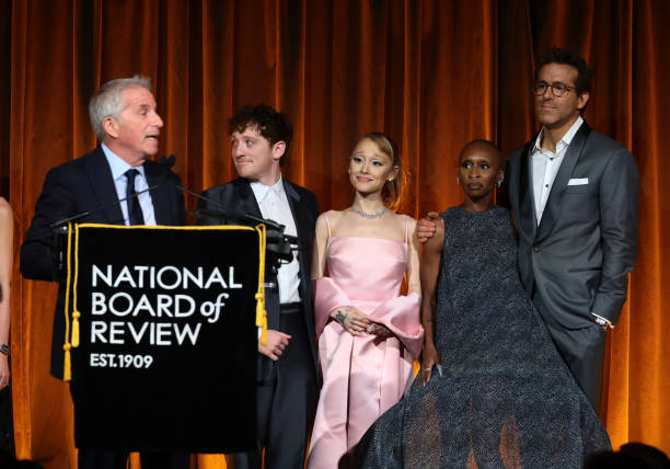 Marc Platt, Ethan Slater, Ariana Grande, and Cynthia Erivo accept the Best Film Award for "Wicked" from Ryan Reynolds onstage during The National Board of Review Annual Awards Gala at Cipriani 42nd Street on January 07, 2025 in New York City. — frame 67/110 (612×428)