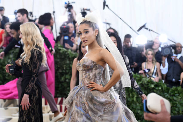 Recording artist Ariana Grande attends the Heavenly Bodies: Fashion & The Catholic Imagination Costume Institute Gala at The Metropolitan Museum of Art on May 7, 2018 in New York City. — frame 1/14 (612×408)