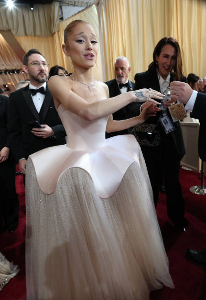 Singer-songwriter Ariana Grande and US visual effects supervisor Daniel MacArin attends the 97th Annual Academy Awards a